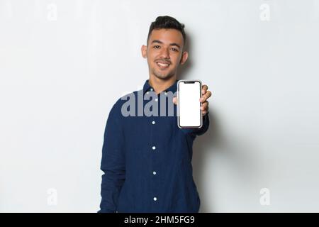 young man demonstrating mobile cell phone on white background Stock Photo