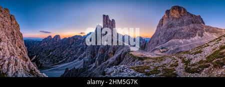 Panoramic aerial view of the mountain hut Rifugio Re Alberto I, summits of Torri di Vajolet (middle) and Cima Catinaccio (right) of Rosengarten group. Stock Photo