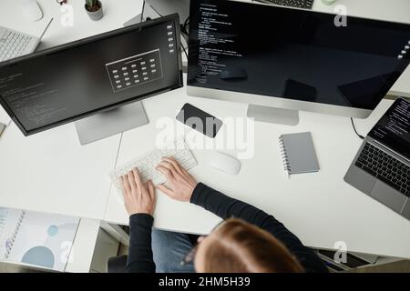 Hands of young contemporary diversity programmer working over new software and decoding data on computer screen Stock Photo