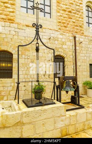 View of a water well, in the yard of the Monastery of Saint Saviour (San Salvador), in the Old City of Jerusalem, Israel. Text: Holy Land Stock Photo