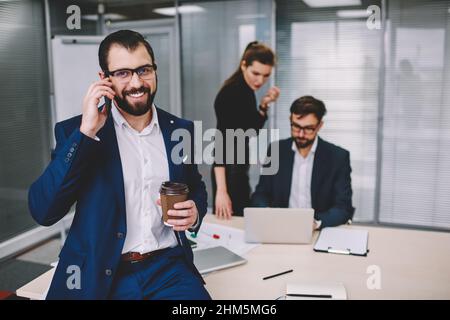 Happy bearded man talking on phone Stock Photo