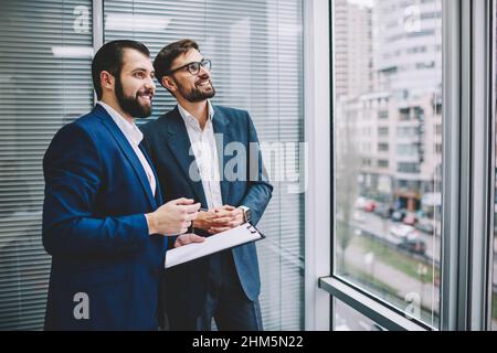 Cheerful managers having conversation in office Stock Photo