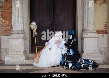 A masked reveller takes part in the Carnival in Venice Stock Photo