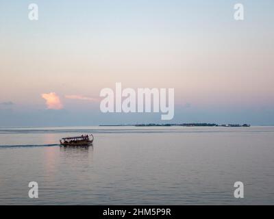 Tranquil image of the Indian Ocean showing a traditional boat dhoni in the foreground Stock Photo