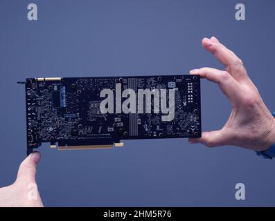 Paris, France - Mar 28, 2019: Presentation module with Senior engineer hands pov holding looking at new GPU Nvidia Quadro RTX 4000 RTX 5000 6000 circuit board - powerful video card gpu Stock Photo
