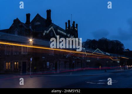 Tavistock Town Hall adorned with Christmas Lights ane vehicle light trails in Tavistock, Devon Stock Photo