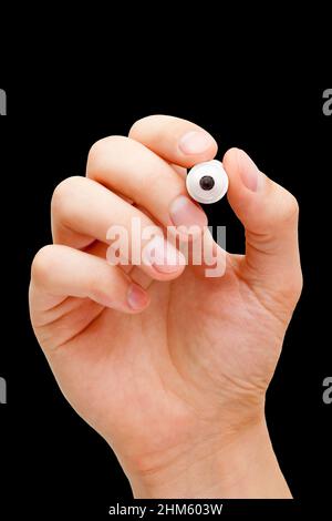 Hand holding white marker isolated on black background with copy space. Stock Photo