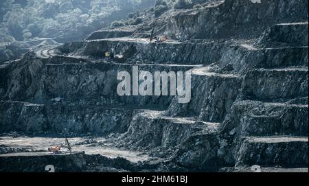 Drilling machines and loader working in diabase (dolerite) quarry Stock Photo