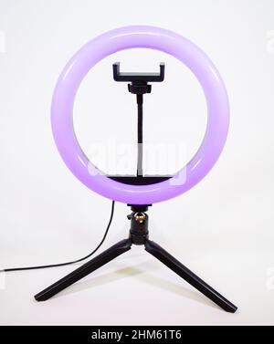 Ring lamp on a small tripod. Purple light. Stock Photo
