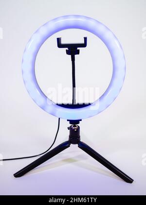 Ring lamp on a small tripod. Blue light. Stock Photo