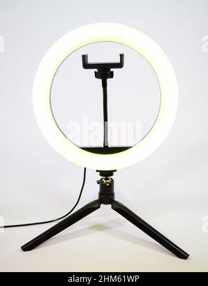 Ring lamp on a small tripod. Yellow light. Stock Photo