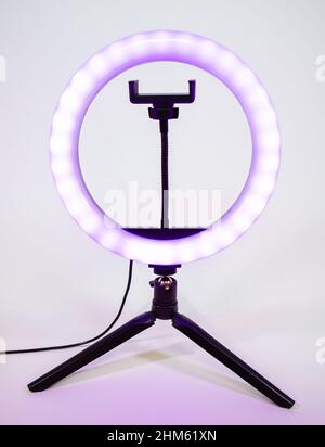 Ring lamp on a small tripod. Purple light. Stock Photo