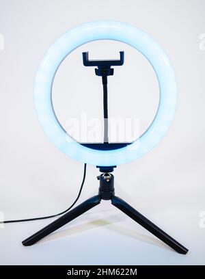 Ring lamp on a small tripod. Blue light. Stock Photo