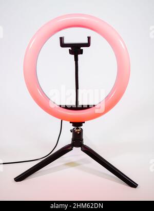 Ring lamp on a small tripod. Red light. Stock Photo