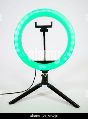Ring lamp on a small tripod. Green light. Stock Photo