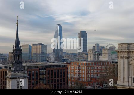 The tower of St Augustine Watling Street next to St Paul's Cathedral in London and two, more modern towers of One Blackfriars and Southbank Stock Photo