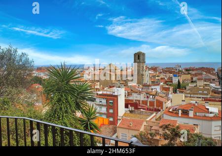 View over the roofs of old town Malgrat de Mar (Spain) from the hill with Mediterranean in the background and the Cathedral of the Coast in the middle Stock Photo