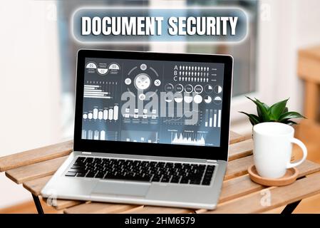 Handwriting text Document Security. Internet Concept maintenance of security of all of the important archives Laptop Resting On A Table Beside Coffee Stock Photo
