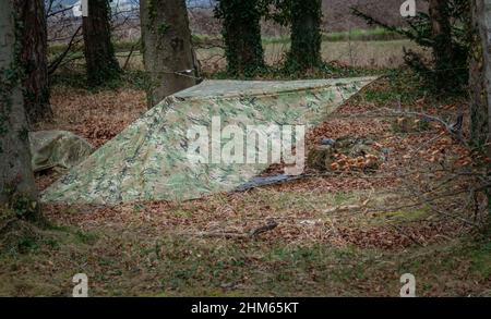 British Army Soldier Camouflage Temporary Tent Cover Erected Amongst A british-army-soldier-camouflage-temporary-tent-cover-erected-amongst-a