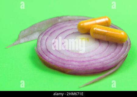 Natural medicine concept, pills on top of onion slice Stock Photo
