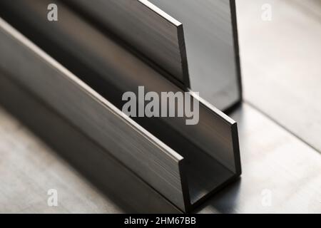 Abstract stack of aluminium profiles close up, industrial background macro, selective focus Stock Photo