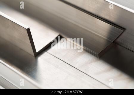 Abstract stack of aluminium profiles close up, industrial background macro, selective focus Stock Photo