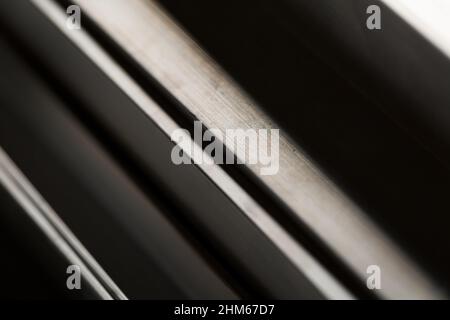 Abstract stack of aluminium profiles close up, industrial background macro, selective focus Stock Photo