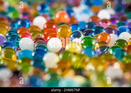 Water beads close-up, abstract background. Texture of Hydrogel balls or many colorful orbeez for wallpaper.