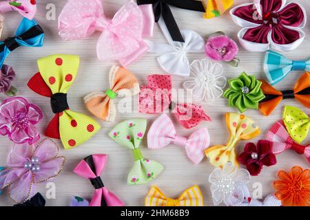 multi-colored decorative fabric bows on a wooden table top view Stock Photo