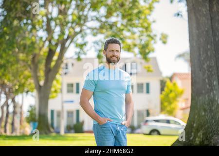 real estate agent at house for sale. realtor welcoming visitors. rent or buy new home. Stock Photo
