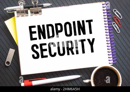 Text ENDPOINT SECURITY on brown paper notepad in businessman hands in office. Business concept Stock Photo