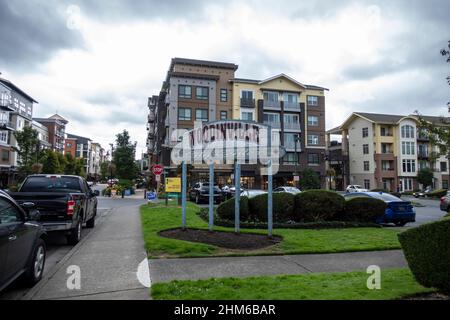 Woodinville, WA USA - circa September 2021: Street view of the Woodinville city center sign outside of a major shopping area on a cloudy, overcast day Stock Photo