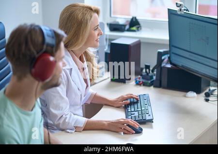 Young man having an appointment at otolaryngologists office Stock Photo