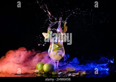 Glass of delicious mojito with splashes on dark background Stock Photo