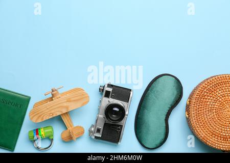 Set of travel items with wooden plane on color background Stock Photo