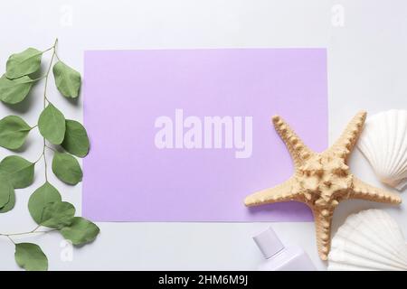 Composition with blank card, eucalyptus branches, seashells and starfish on white background, closeup Stock Photo