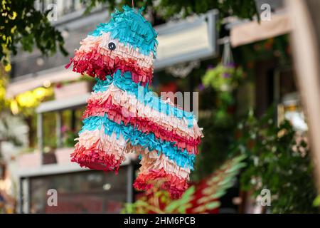 Mexican pinata in shape of horse hanging outdoors Stock Photo