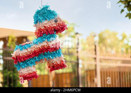 Mexican pinata in shape of horse hanging outdoors Stock Photo