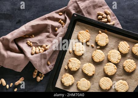 Baking sheet with tasty peanut cookies on black background, closeup Stock Photo