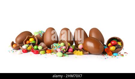 Delicious chocolate Easter eggs with different candies on white background Stock Photo