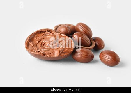 Different delicious Easter eggs with chocolate paste on light background Stock Photo