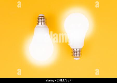 A Power Saving Lamps on Yellow Background - Top View Stock Photo