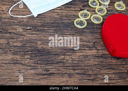Valentine Concept The red heart represents love and protection against sexually transmitted diseases and pregnancy without condoms, as well as prevent Stock Photo