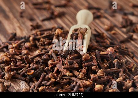 Dried spice herbs cloves for flavoring foods and natural medicines, Indian spice ingredient on wooden background. Stock Photo