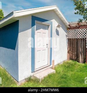 Square Whispy white clouds Small shed with blue and white color located in Utah Stock Photo