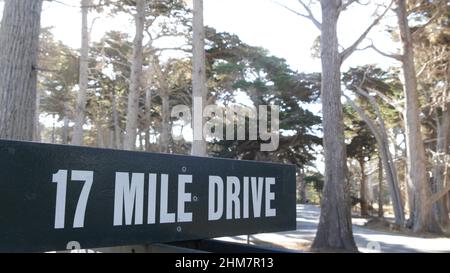 Scenic 17-mile drive wooden road sign, Monterey peninsula, Big Sur, California, USA. Coastal roadtrip, cypress forest. Pacific coast highway tourist route. Hitchhiking trip, ecotourism on vacations. Stock Photo