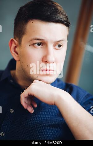 Confident boyfriend seriously looking at side and thinking. Stock Photo