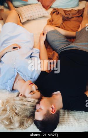 Above view of positivity couple laying together on back and happy smiling. Stock Photo