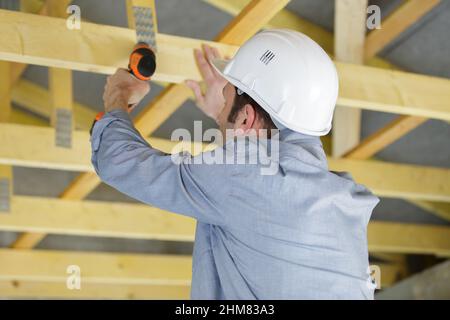 male builder using a cordless screwdriver Stock Photo