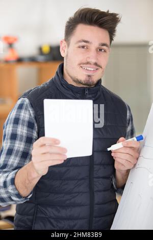 portrait of smiling worker holding blank billboard Stock Photo